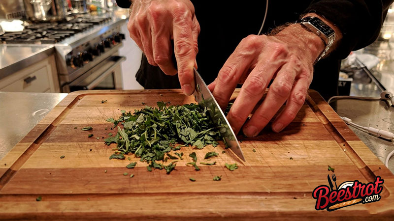 The Best Ingredient I Ever Added to My Kitchen Had Nothing to Do with Food 2 hands chopping fresh herbs